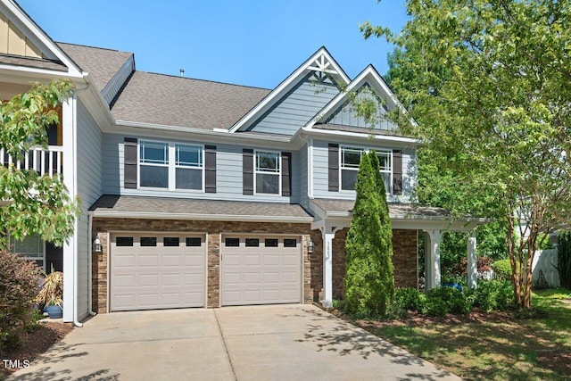 3002 Bartlett Cir, Hillsborough, NC 27278 - view of front of property with an attached garage, concrete driveway, a shingled roof, board and batten siding, and stone siding