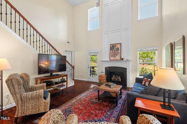 3002 Bartlett Cir, Hillsborough, NC 27278 - living area featuring a high ceiling, stairs, wood finished floors, a large fireplace, and baseboards