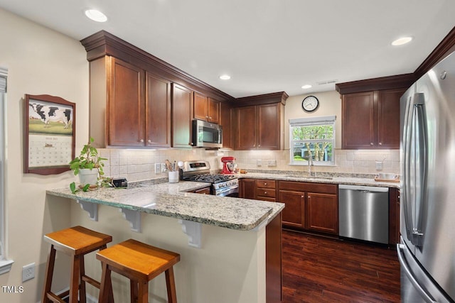 3002 Bartlett Cir, Hillsborough, NC 27278 - kitchen featuring stainless steel appliances, a sink, a peninsula, dark wood-style flooring, and tasteful backsplash