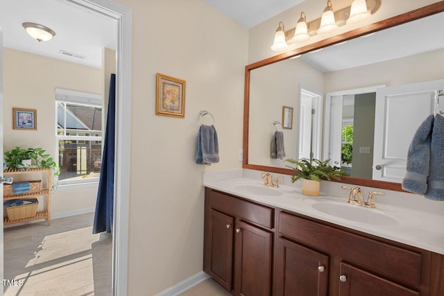 3002 Bartlett Cir, Hillsborough, NC 27278 - full bathroom featuring double vanity, tile patterned floors, and baseboards