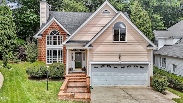 traditional-style house with roof with shingles, concrete driveway, a chimney, a front lawn, and brick siding