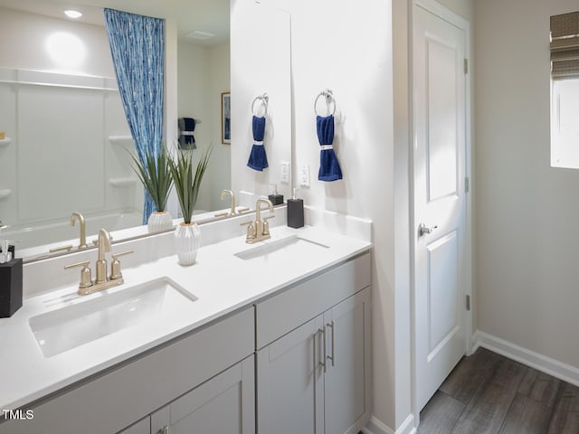 2242 Cherry Creek Rd, Haw River, NC 27258 - full bathroom featuring wood finished floors, baseboards, double vanity, and bathing tub / shower combination