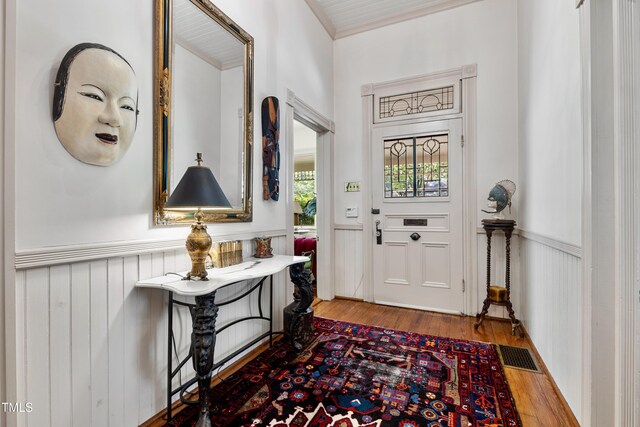 517 N E St, Raleigh, NC 27604 - entryway featuring wainscoting, wood finished floors, and crown molding