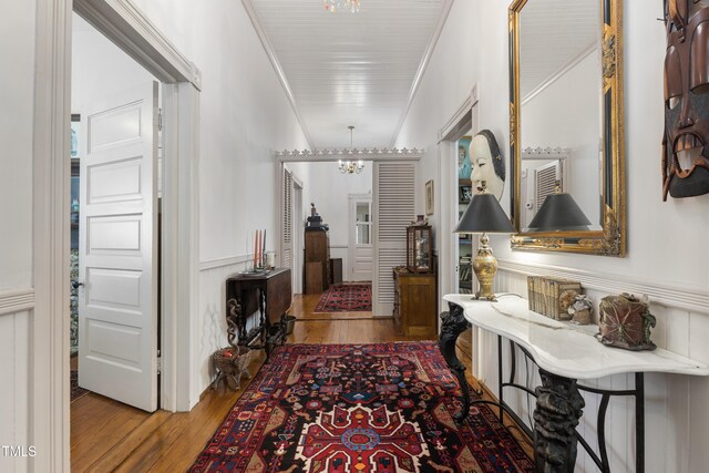 517 N E St, Raleigh, NC 27604 - hall with wood finished floors, a chandelier, wainscoting, and ornamental molding