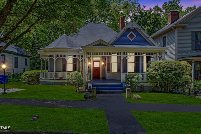 517 N E St, Raleigh, NC 27604 - victorian home featuring covered porch and a front lawn