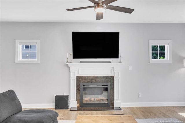607 Rempstone Ln, Fayetteville, NC 28311 - living area featuring a glass covered fireplace, wood finished floors, ceiling fan, and baseboards