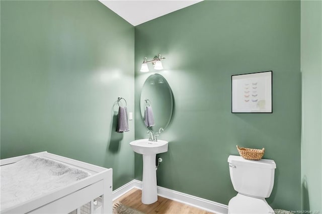 607 Rempstone Ln, Fayetteville, NC 28311 - bathroom with baseboards, wood finished floors, and toilet