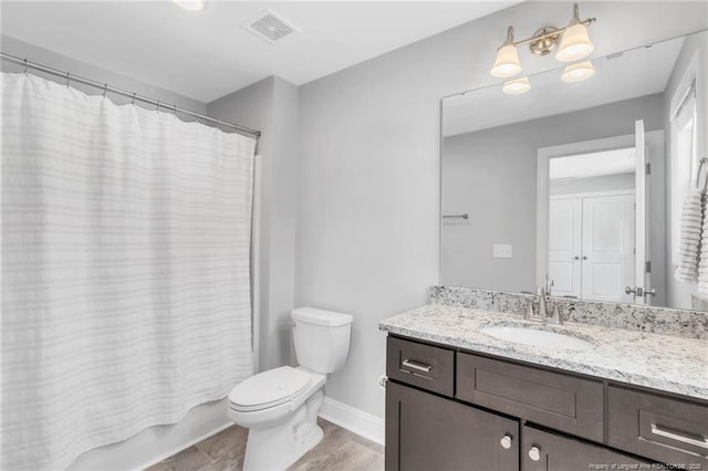 607 Rempstone Ln, Fayetteville, NC 28311 - bathroom featuring toilet, vanity, baseboards, wood finished floors, and shower / bath combination with curtain
