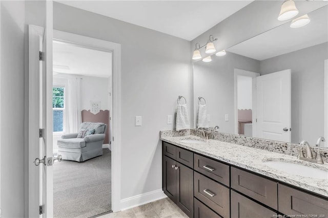607 Rempstone Ln, Fayetteville, NC 28311 - ensuite bathroom with double vanity and baseboards