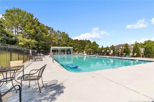 607 Rempstone Ln, Fayetteville, NC 28311 - community pool featuring a patio area and view of scattered trees