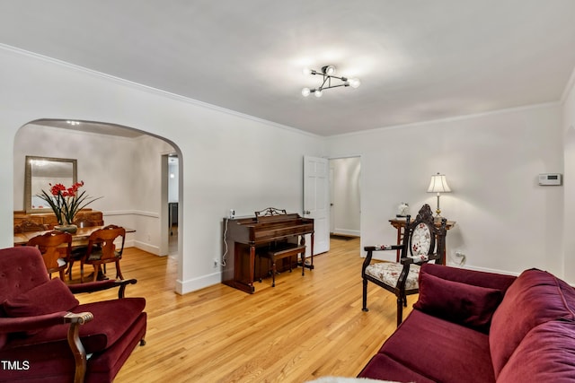 1304 N Duke St, Durham, NC 27701 - living area featuring arched walkways, crown molding, light wood-style floors, and baseboards