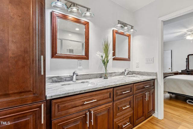 1304 N Duke St, Durham, NC 27701 - bathroom with double vanity, wood finished floors, connected bathroom, and a ceiling fan