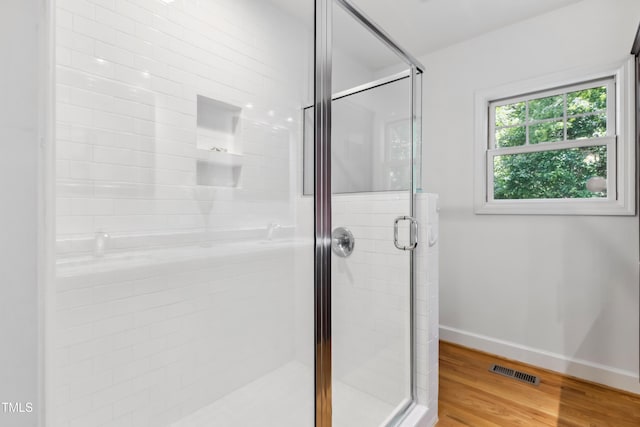 1304 N Duke St, Durham, NC 27701 - bathroom with a shower stall, baseboards, and wood finished floors