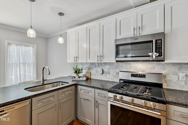 1304 N Duke St, Durham, NC 27701 - kitchen with stainless steel appliances, a sink, decorative backsplash, ornamental molding, and pendant lighting
