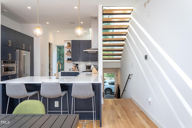 414 Chavis Way, Raleigh, NC 27601 - kitchen featuring appliances with stainless steel finishes, a kitchen breakfast bar, backsplash, a sink, and recessed lighting