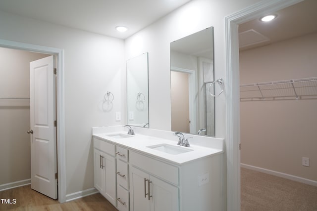2106 Cherry Creek Rd, Haw River, NC 27258 - bathroom featuring double vanity, a spacious closet, baseboards, and recessed lighting