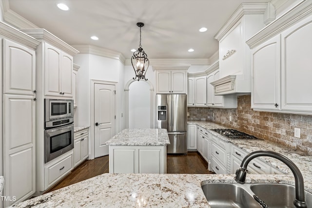 3908 Chaumont Dr, Apex, NC 27539 - kitchen featuring appliances with stainless steel finishes, a sink, pendant lighting, dark wood finished floors, and light stone counters