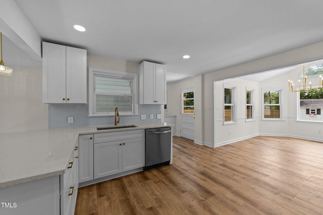 314 Wrenn St, Apex, NC 27502 - kitchen featuring a sink, dishwasher, a chandelier, decorative backsplash, and wood finished floors