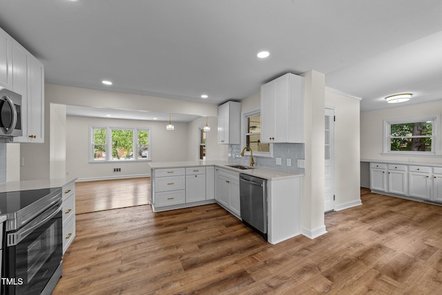 314 Wrenn St, Apex, NC 27502 - kitchen featuring appliances with stainless steel finishes, a sink, light countertops, wood finished floors, and baseboards