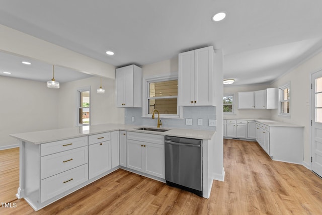 314 Wrenn St, Apex, NC 27502 - kitchen featuring stainless steel dishwasher, a peninsula, a sink, light wood-style flooring, and white cabinetry
