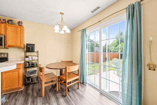 5312 Suntan Lake Dr, Raleigh, NC 27610 - dining area featuring wood finished floors and a chandelier