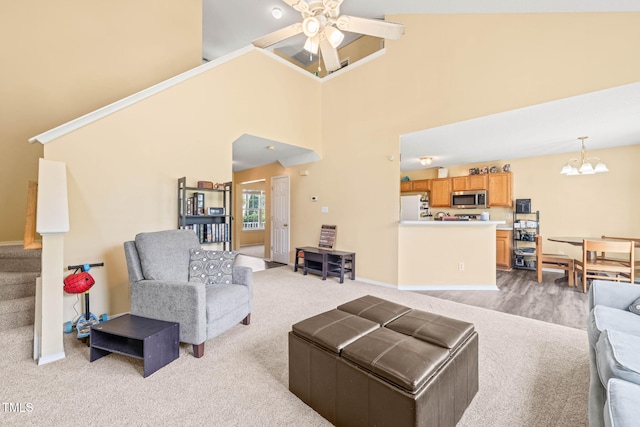5312 Suntan Lake Dr, Raleigh, NC 27610 - living room with a chandelier, light carpet, a ceiling fan, baseboards, and a high ceiling