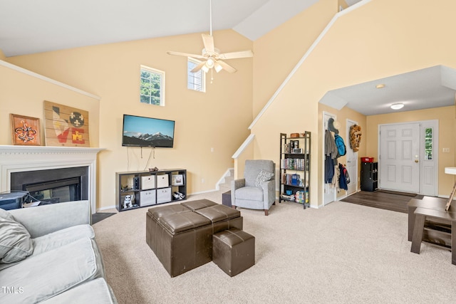 5312 Suntan Lake Dr, Raleigh, NC 27610 - carpeted living area featuring stairs, high vaulted ceiling, plenty of natural light, ceiling fan, and a glass covered fireplace