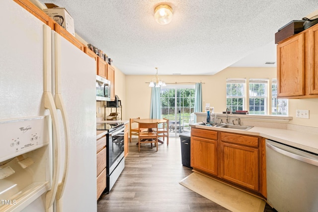 5312 Suntan Lake Dr, Raleigh, NC 27610 - kitchen with appliances with stainless steel finishes, a sink, a textured ceiling, wood finished floors, and light countertops