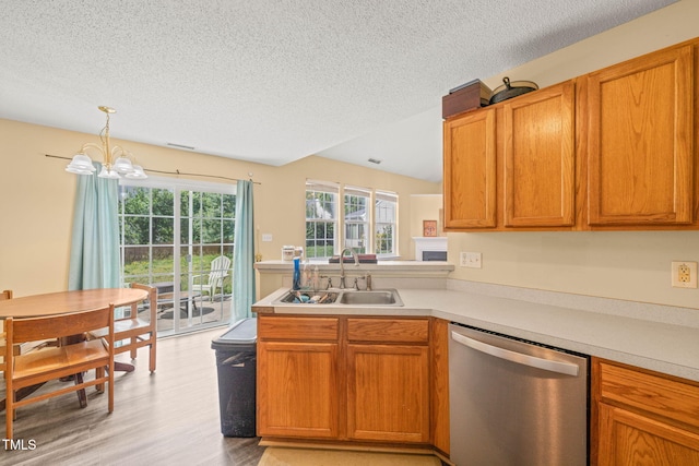 5312 Suntan Lake Dr, Raleigh, NC 27610 - kitchen featuring stainless steel dishwasher, a sink, a textured ceiling, light countertops, and plenty of natural light