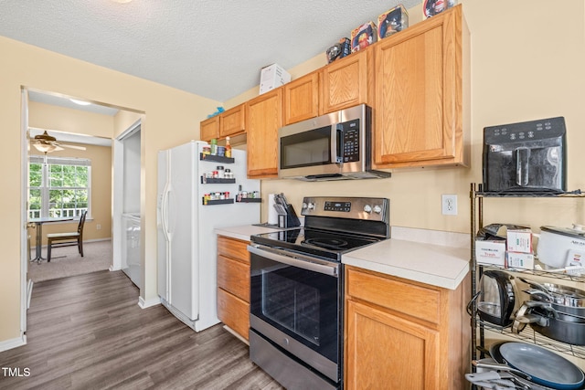 5312 Suntan Lake Dr, Raleigh, NC 27610 - kitchen with appliances with stainless steel finishes, light countertops, dark wood-style floors, ceiling fan, and baseboards