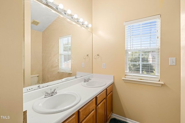 5312 Suntan Lake Dr, Raleigh, NC 27610 - full bath with plenty of natural light, double vanity, and toilet