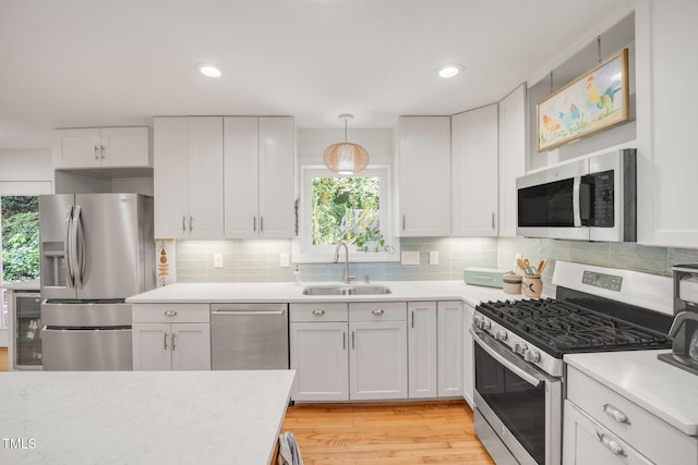 4021 Converse Dr, Raleigh, NC 27609 - kitchen with stainless steel appliances, a sink, healthy amount of natural light, light countertops, and recessed lighting