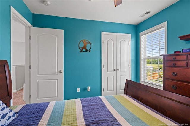 bedroom featuring a closet, a ceiling fan, and carpet flooring