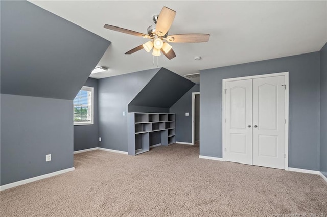 additional living space with carpet flooring, a ceiling fan, and baseboards