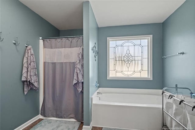 full bath featuring a bath, baseboards, and curtained shower