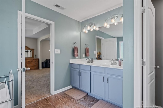 full bathroom featuring double vanity and baseboards
