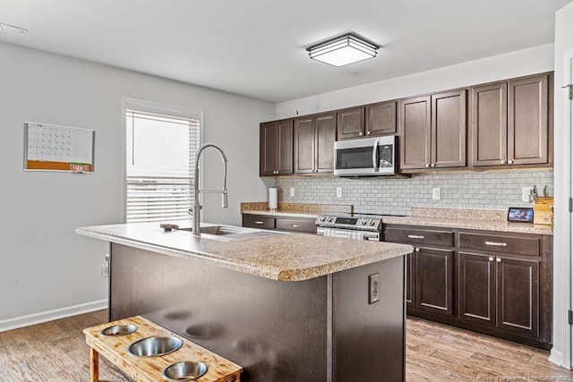 34 Merlin Ct, Godwin, NC 28344 - kitchen with appliances with stainless steel finishes, a sink, light countertops, and backsplash