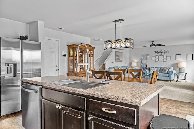 34 Merlin Ct, Godwin, NC 28344 - kitchen with a sink, stainless steel appliances, open floor plan, ceiling fan, and an island with sink