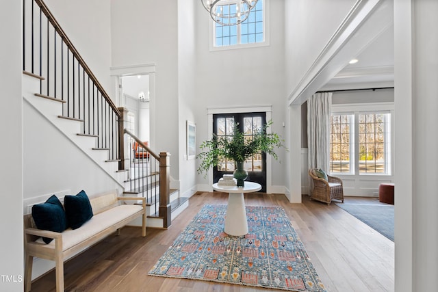 7212 Summer Tanager Trl, Raleigh, NC 27614 - foyer entrance featuring a towering ceiling, stairway, a chandelier, and hardwood / wood-style flooring