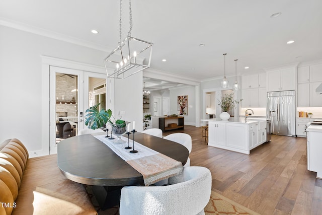 7212 Summer Tanager Trl, Raleigh, NC 27614 - dining area featuring crown molding, recessed lighting, a chandelier, and light wood-type flooring