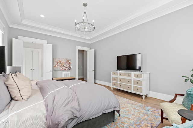 7212 Summer Tanager Trl, Raleigh, NC 27614 - bedroom featuring a chandelier, ornamental molding, a raised ceiling, wood finished floors, and recessed lighting