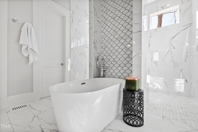 7212 Summer Tanager Trl, Raleigh, NC 27614 - full bathroom featuring marble finish floors, a freestanding tub, a marble finish shower, and tile walls