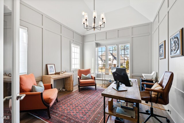 7212 Summer Tanager Trl, Raleigh, NC 27614 - home office featuring a decorative wall, a chandelier, wood finished floors, and lofted ceiling