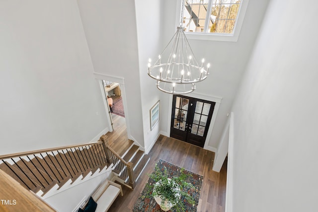 7212 Summer Tanager Trl, Raleigh, NC 27614 - foyer featuring a chandelier, stairs, a towering ceiling, and wood finished floors