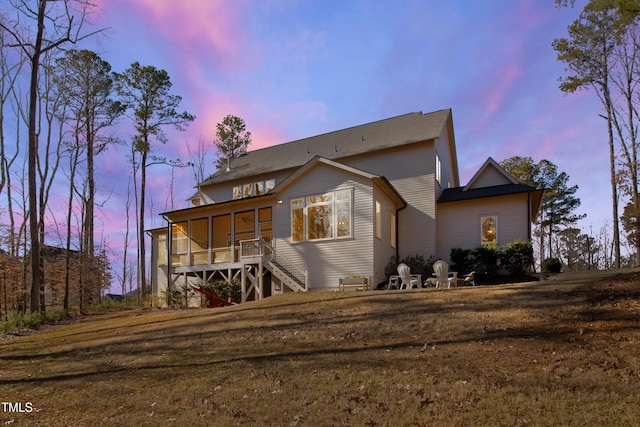 7212 Summer Tanager Trl, Raleigh, NC 27614 - back of property at dusk featuring a sunroom and stairs