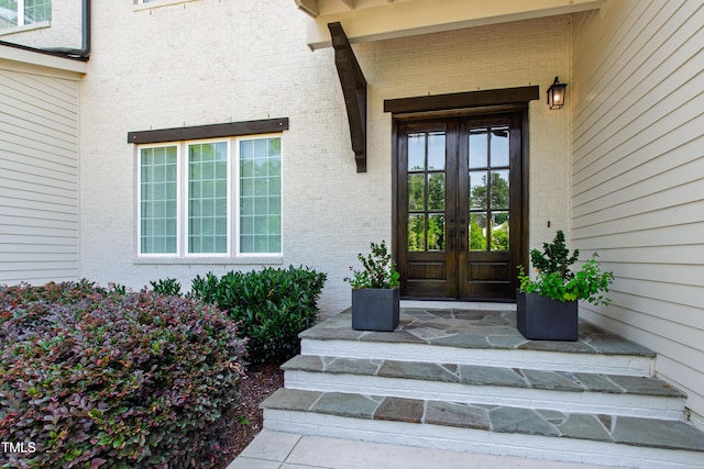 7212 Summer Tanager Trl, Raleigh, NC 27614 - view of exterior entry with french doors and brick siding