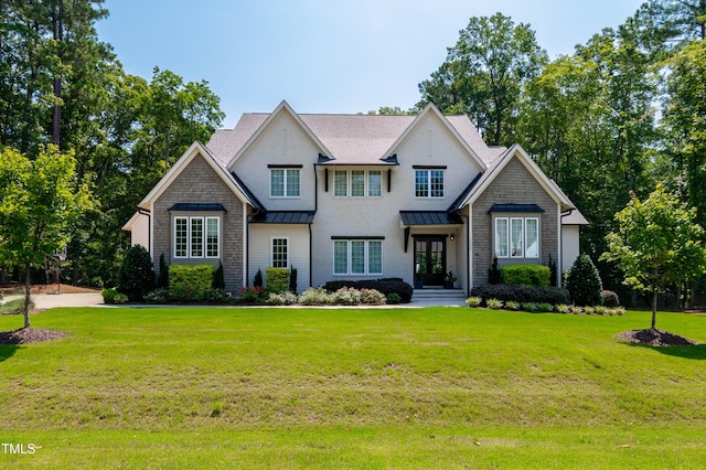 7212 Summer Tanager Trl, Raleigh, NC 27614 - view of front of home with french doors, a standing seam roof, a front lawn, and a metal roof