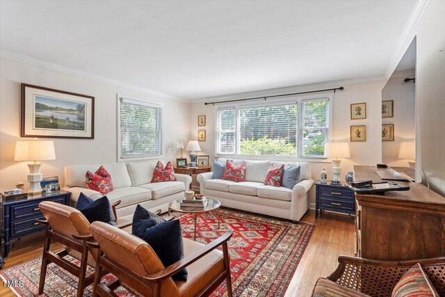 2913 Anderson Dr, Raleigh, NC 27608 - living area featuring healthy amount of natural light, wood finished floors, and crown molding