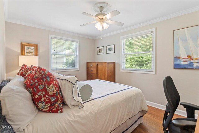 2913 Anderson Dr, Raleigh, NC 27608 - bedroom featuring multiple windows, wood finished floors, ornamental molding, baseboards, and a ceiling fan