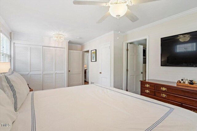 2913 Anderson Dr, Raleigh, NC 27608 - bedroom with crown molding, a closet, and a chandelier